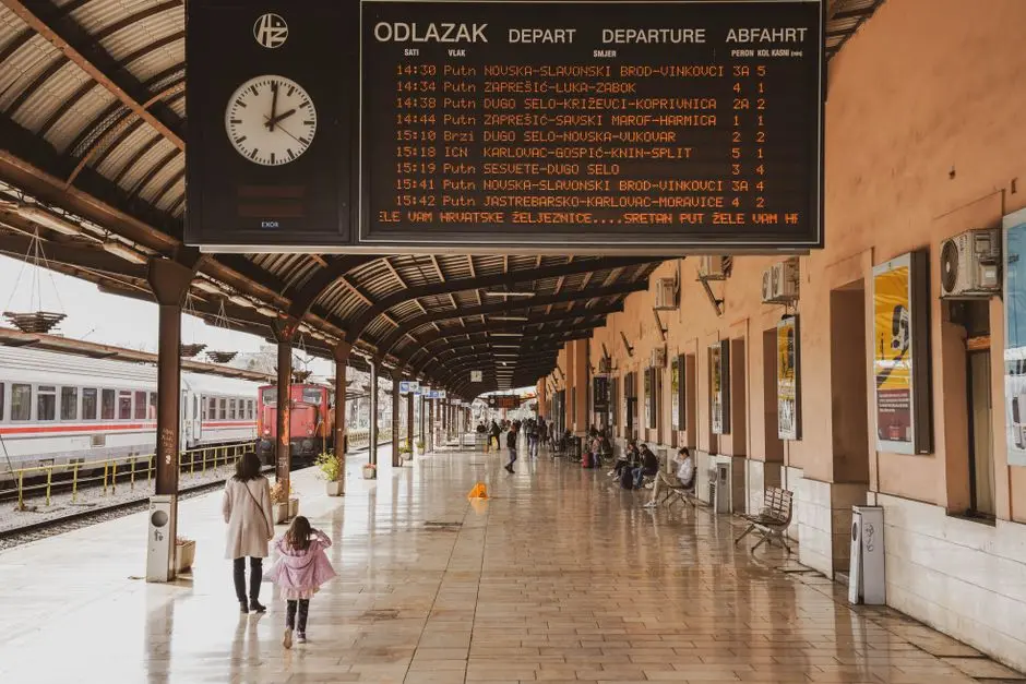 Suasana peron KRL dengan papan jadwal